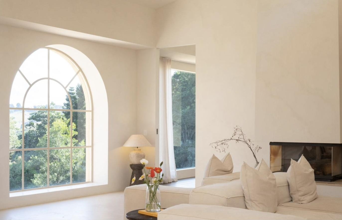 Living room with arched window and fireplace, Komorebi Home